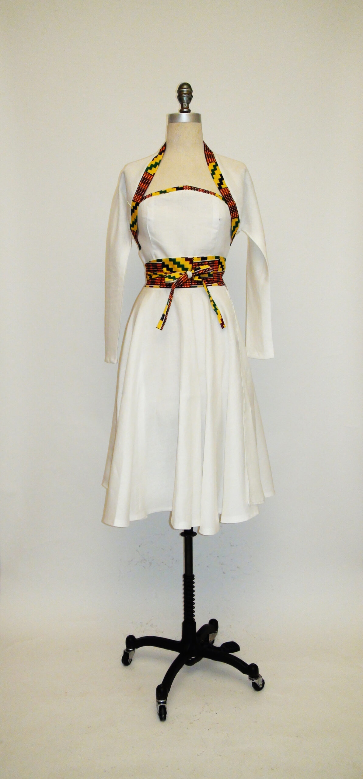 White Linen Shrug, Bustier and Circle Skirt Trimmed In African-Inspired Fabric.